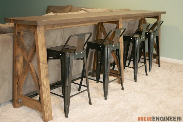 console table with chairs behind couch