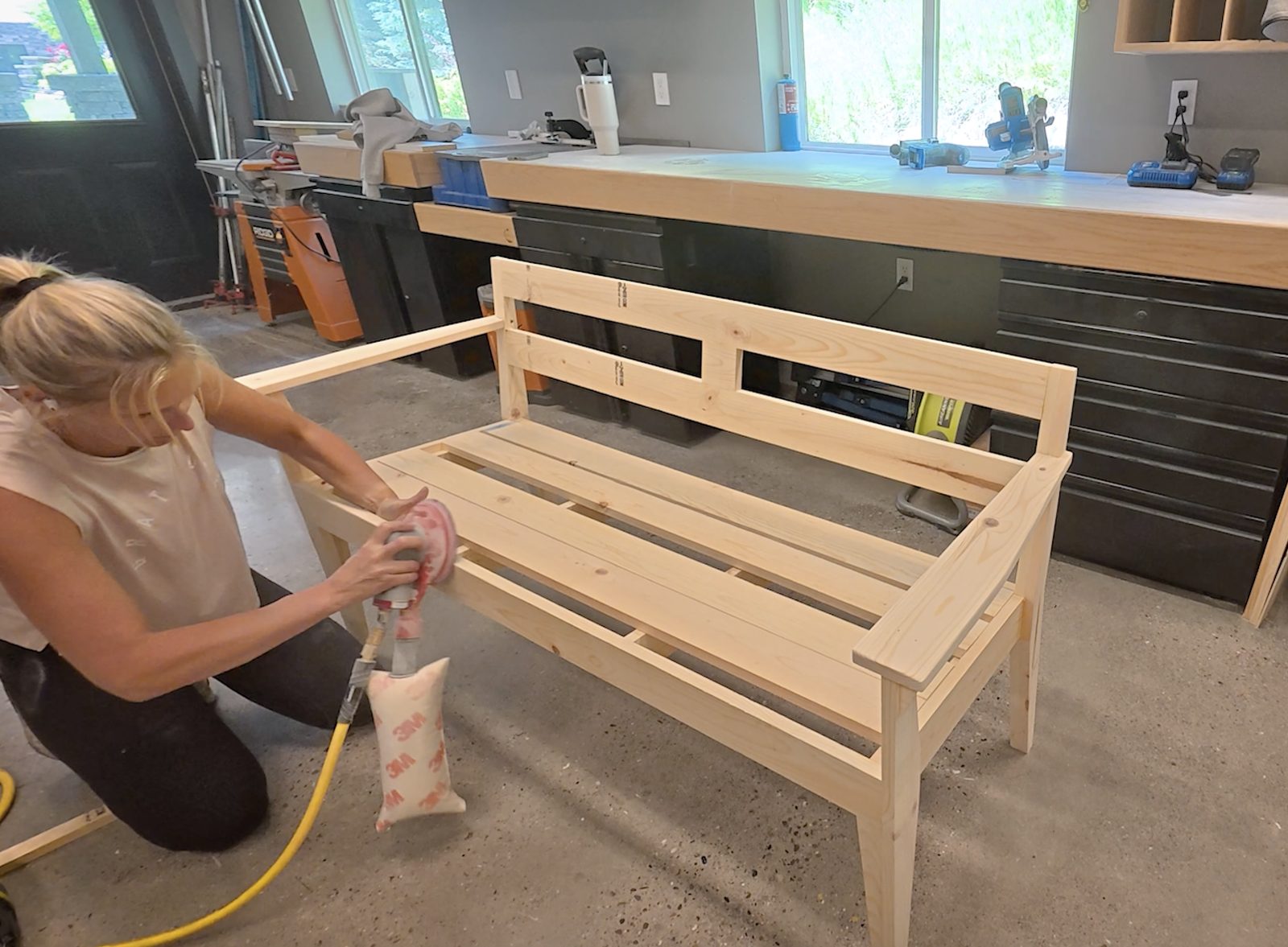 Sanding the assembled garden bench frame