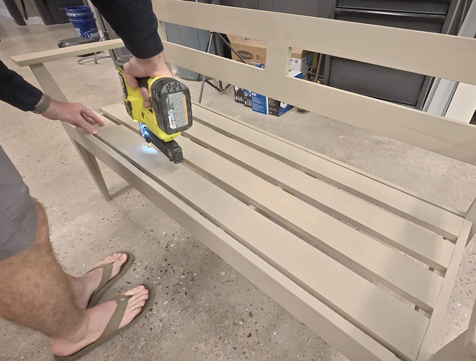 Brad-nailing the pre-stained seat slats onto the bench