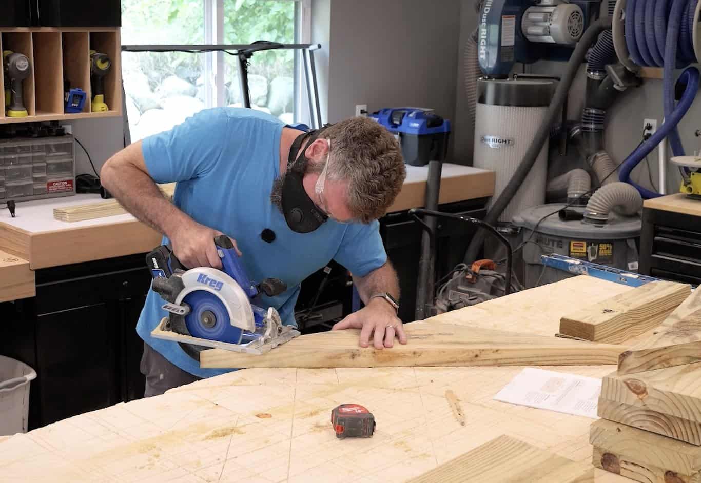 Cutting the long diagonal of the back leg profile out of a 2x8 with a circular saw