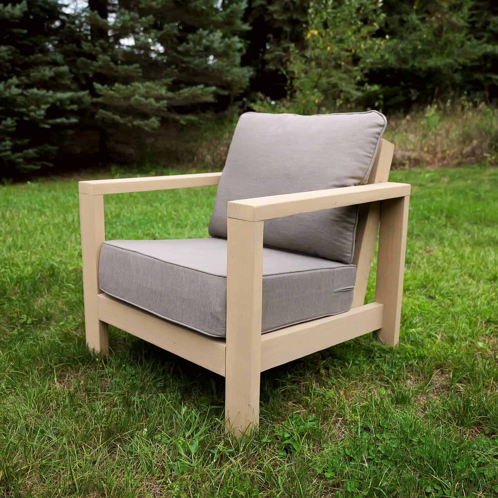 Finished DIY outdoor chair built from 2x4s and 2x6s with a gray cushion
