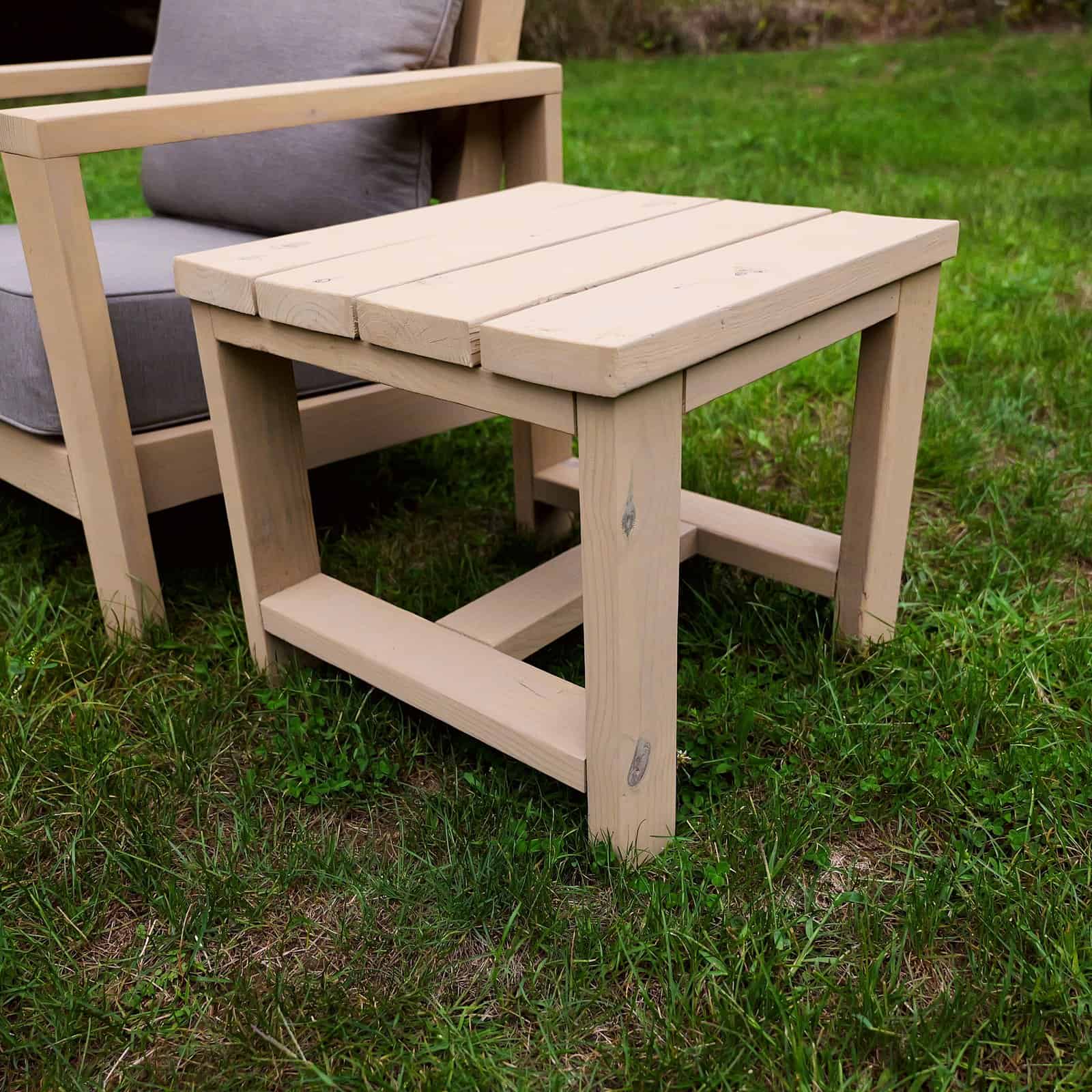 DIY outdoor side table built from 2x4s and 2x6s next to a matching chair
