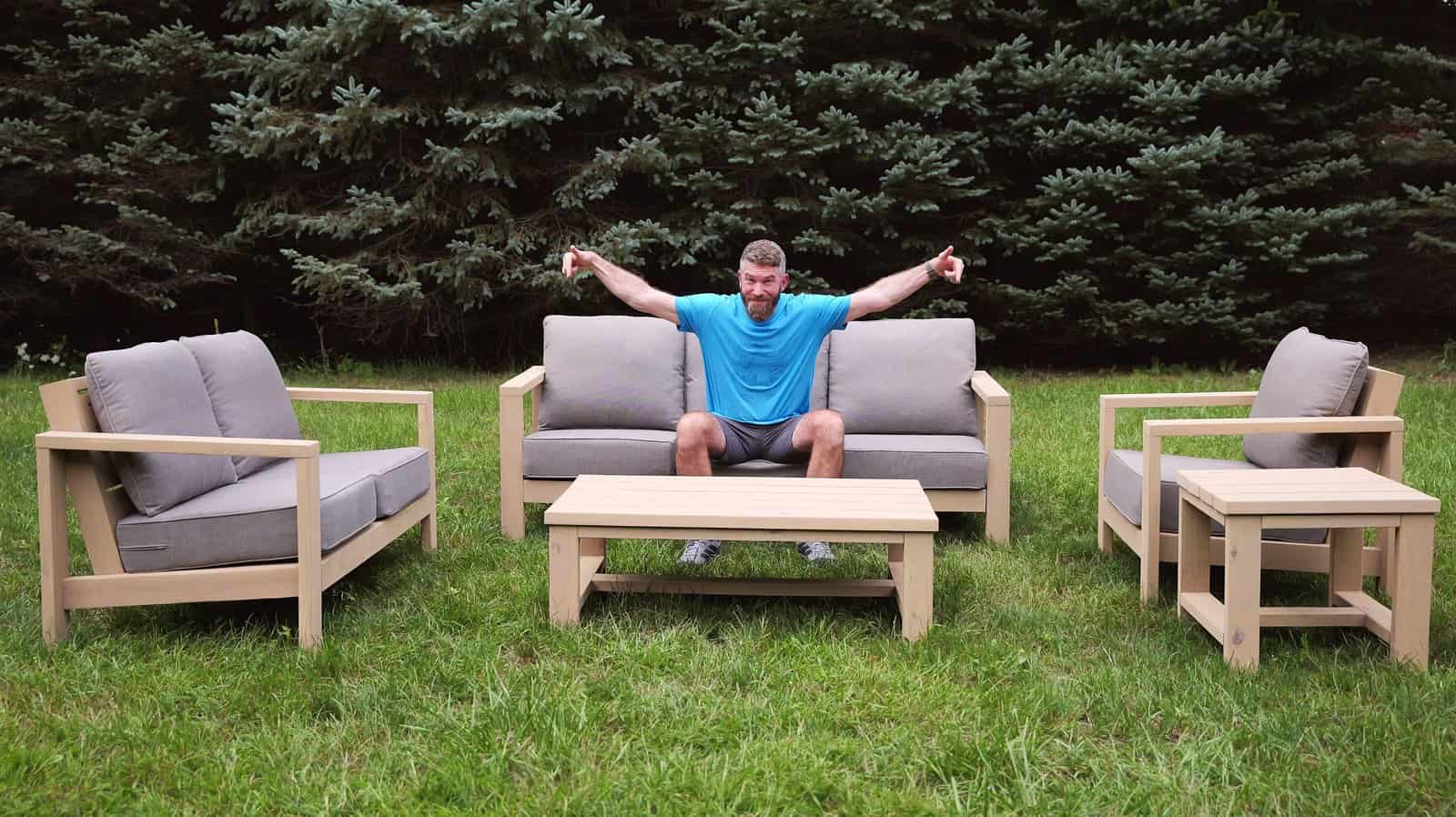 Jamison Rantz sitting on a finished DIY patio furniture set built from 2x4s and 2x6s