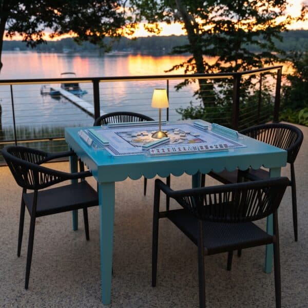 DIY folding mahjong table set for game night on a lake deck at sunset