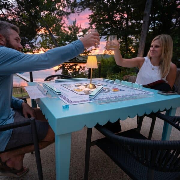 Two people playing mahjong at the DIY folding table at sunset