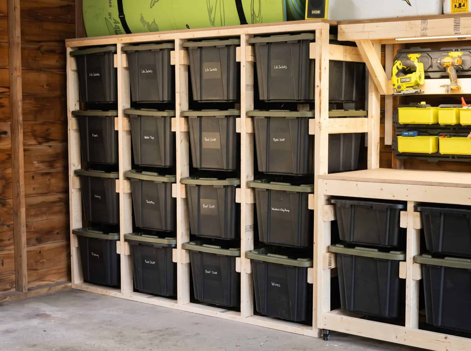 2x4 tote storage rack holding 16 labeled HDX totes in a garage