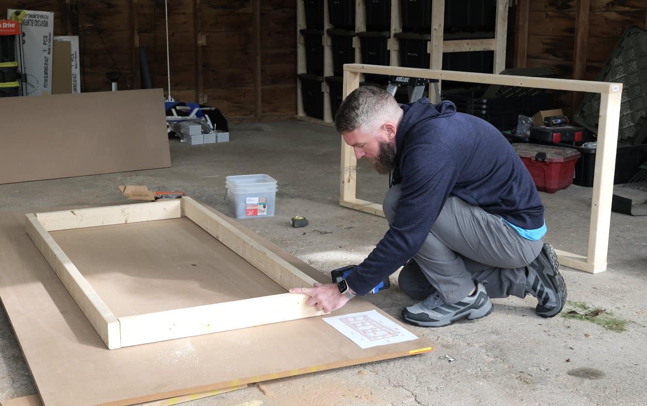 Squaring up one of the two 2x4 frames for the mobile workbench, the second frame leaning behind