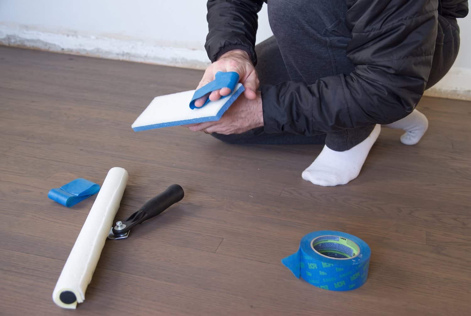 Painter's tape removing loose fibers from the T-bar applicator before poly