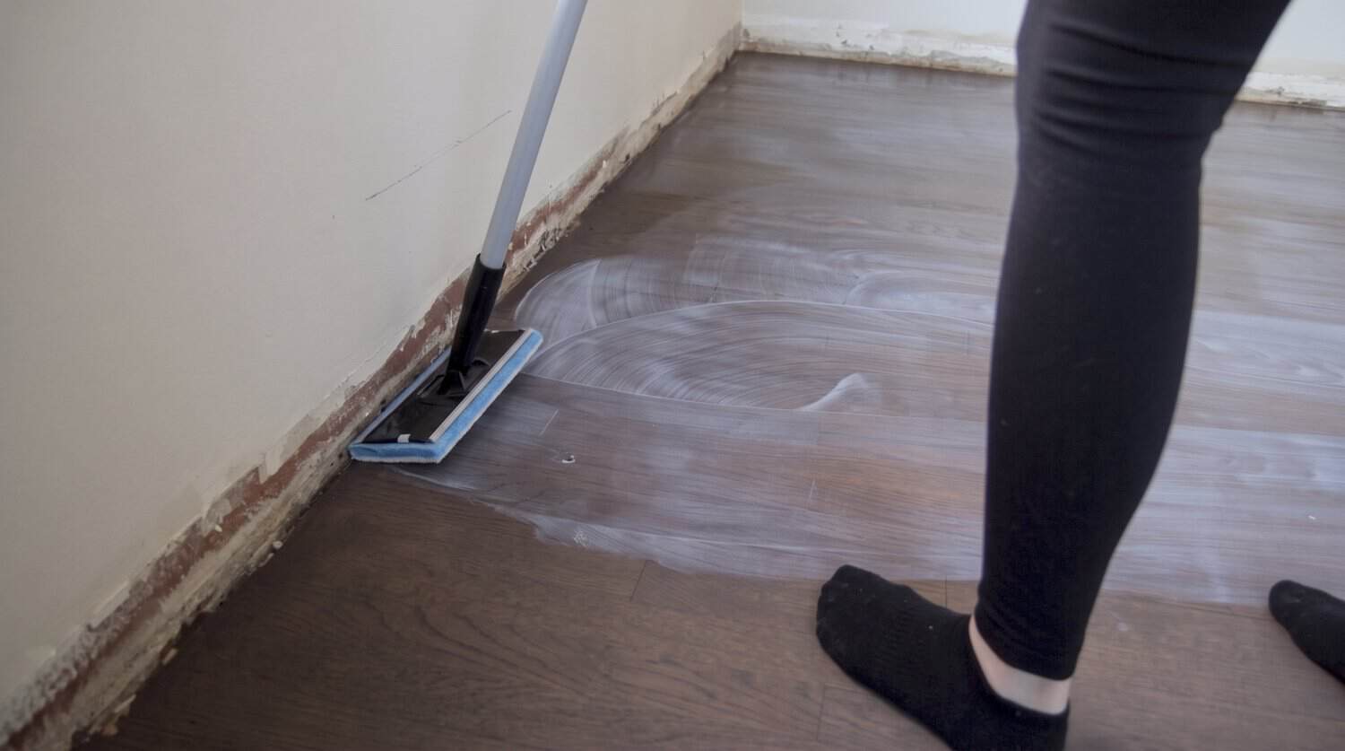 Edger pad applying floor finish along the wall