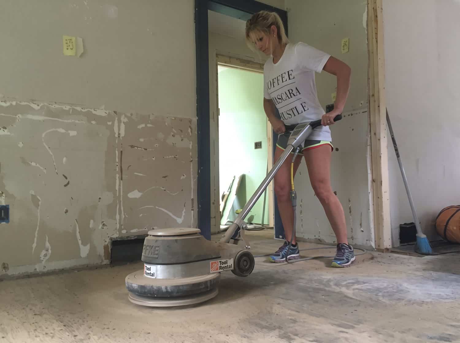 Running the floor polisher with the wood tool to take mastic down to bare wood