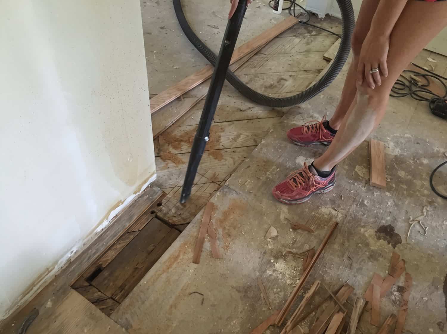 Cutting out damaged floor boards where a wall was removed